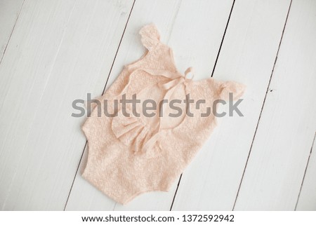 suit for newborns. peach bodysuit for baby. suit for girls