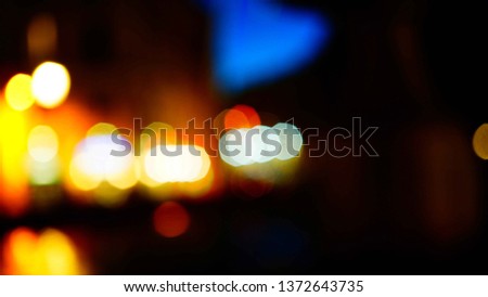 Blurred of a city street with buildings and streetlights in the evening. usable image as background in post production