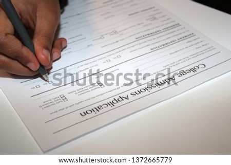 Student submitting her application for college admission. Royalty-Free Stock Photo #1372665779