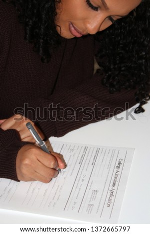 Student submitting her application for college admission. Royalty-Free Stock Photo #1372665797