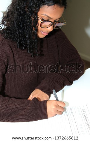 Student submitting her application for college admission. Royalty-Free Stock Photo #1372665812