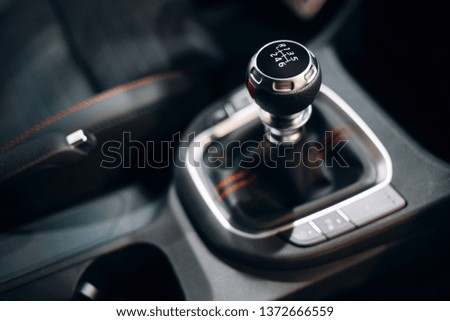Manual gearbox handle inside the modern car. Gear shift stick close up. 6 manual gearbox shifter Royalty-Free Stock Photo #1372666559