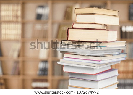 concept of education: book in library (with very blurred background)
