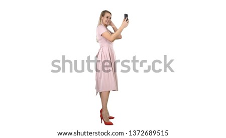 Beautiful woman preen looking to her phone on white background.