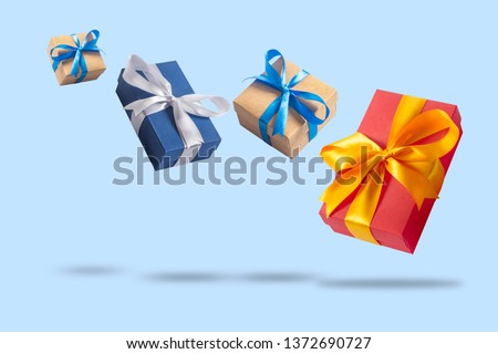 Many Flying Gift Boxes on a light blue background. Holiday concept, gift, sale, wedding and birthday. Royalty-Free Stock Photo #1372690727