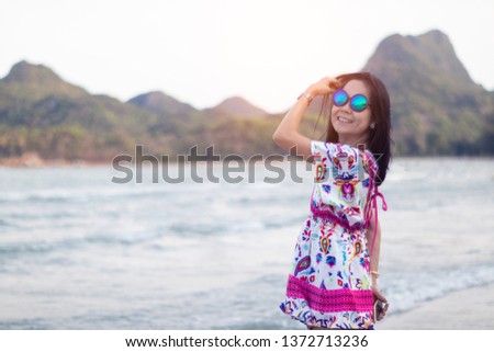 Asian smile woman in summer vintage dress on beach