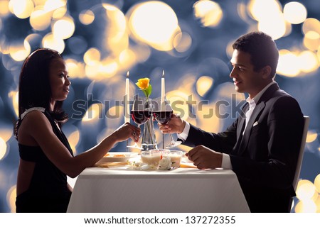 Portrait Of Romantic Couple Toasting Red Wine At Dinner Royalty-Free Stock Photo #137272355