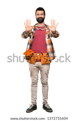 Craftsmen man counting ten with fingers over isolated white background
