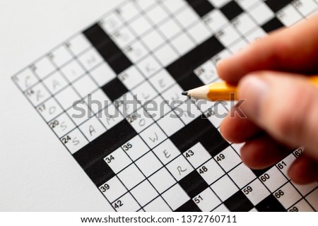 Black and white crossword puzzle that needs to be solved Royalty-Free Stock Photo #1372760711