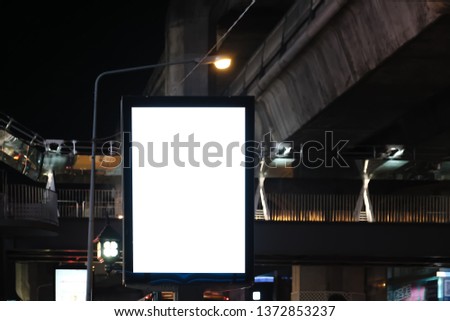 big blank billboard white LED screen vertical outstanding in the city on pathway side the road traffic with car for display advertisement text template promotion new brand at outdoor.