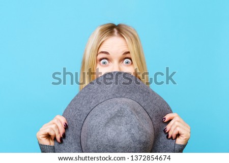 Photo of blonde covering her face with hat