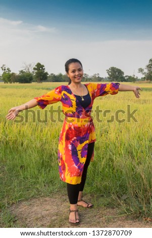 Beautiful young Thai in a colorful dress at a temple