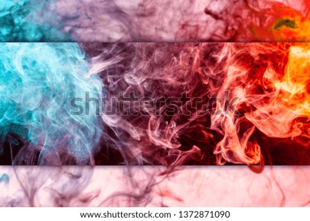 Thick colorful smoke of red and  blue on a black and white isolated background. Background from the smoke of vape

