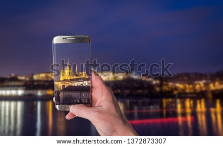 Man taking photo of Czech capitol city Prague and river Vltava, Prague castle at night, landscape photography