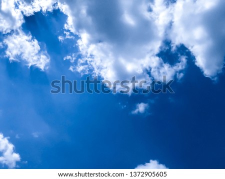 The bright blue sky, white clouds and soft wind blowing in the summer. Bottom view.