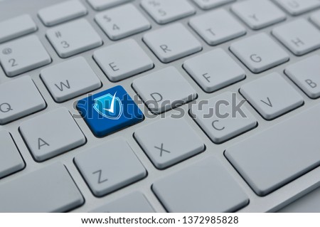 Security shield with check mark flat icon on modern computer keyboard button, Technology internet cyber security and anti virus concept