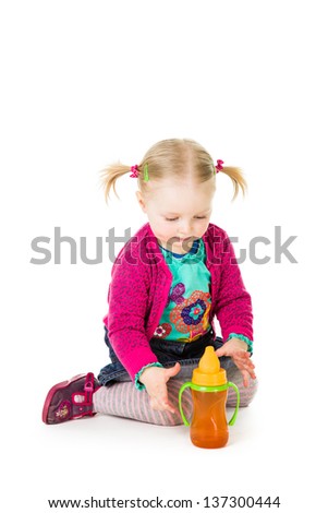 Baby girl drinking tea from bottle