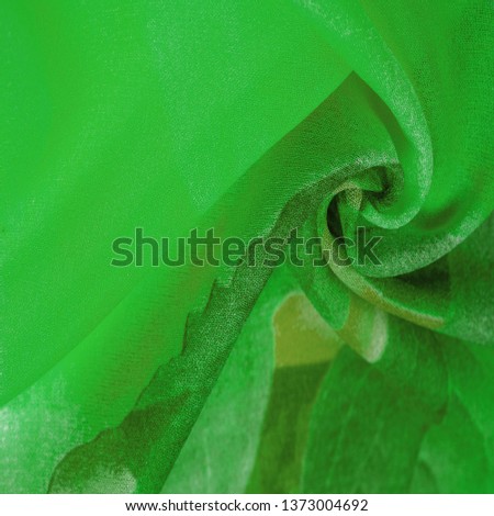 Texture, background, pattern, postcard, silk fabric, women's colored scarf with green white flowers. The gorgeous design is based on attractive background images. You will be the best Royalty-Free Stock Photo #1373004692