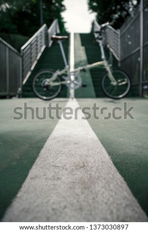 abstract blur and defocused of bicycle and sky green lane as park connector for background
