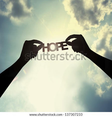 holding a paper cut of hope Royalty-Free Stock Photo #137307233