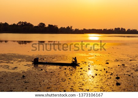 Evening sun hits the reservoir And the boat of the fisherman And beautiful evening atmosphere background Space