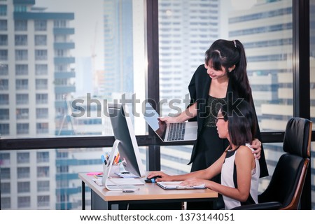 Business people or beautiful lady officer talking or meeting on workplace or desk with computer and window glass city view background