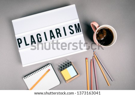 Plagiarism. Text in light box. Pink coffee mug on gray background