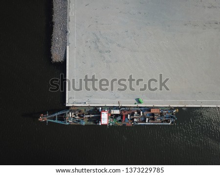 drone shot of a cargo ship in the Harbour