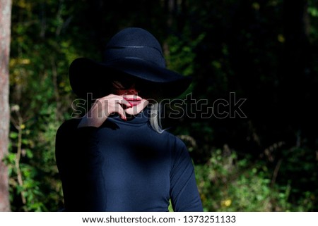 Happy young fashion woman in autumn forest.