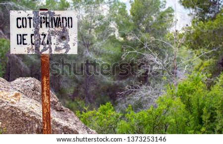 Sign in the field of Private property prohibition against a landscape. Restricted access in Murcia Spain 2019. Private area. Warning sign to no trespassing.