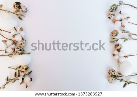 Easter eggs on a white background with a sprig of willow
