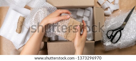 Packing products for delivery, shipping service. Delivery concept for private companies delivery with care , Craft present box Royalty-Free Stock Photo #1373296970