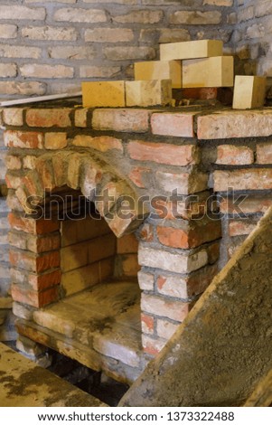 Building a fireplace in a house using old bricks. Beautiful bricklaying.
