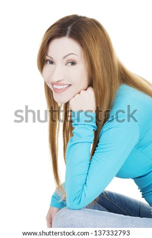 Happy attractive woman sitting, isolated on white
