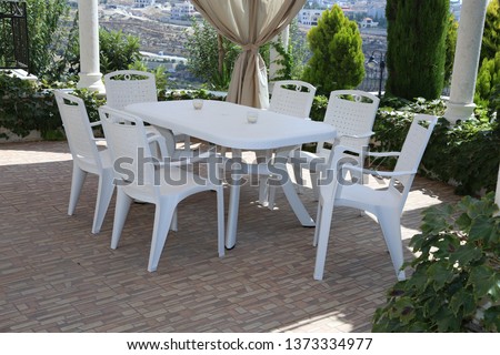 plastic Chairs and tables with different colors in the garden