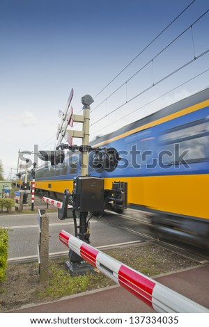 high speed train passing a railroad crossing in the Netherlands
