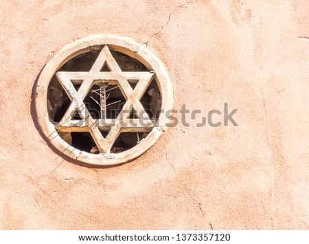 Star of David Embedded in the Wall of a Medieval Synagogue In Taormina, Sicily, Italy Royalty-Free Stock Photo #1373357120
