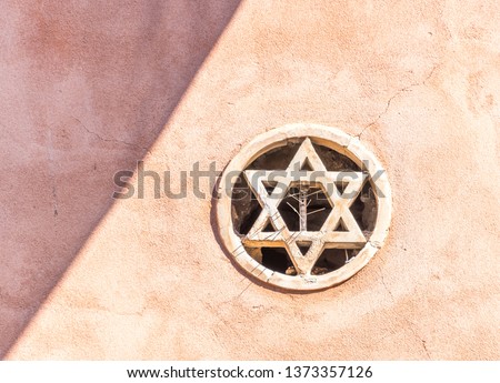 Star of David Embedded in the Wall of a Medieval Synagogue In Taormina, Sicily, Italy Royalty-Free Stock Photo #1373357126
