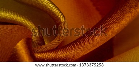 Texture, background, yellow silk striped fabric with a metallic sheen. Royalty-Free Stock Photo #1373375258