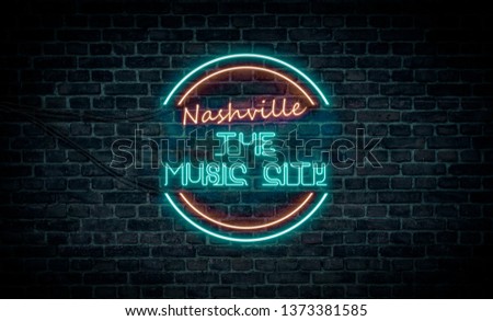 A red and blue neon light sign that reads:
Nashville the Music City
