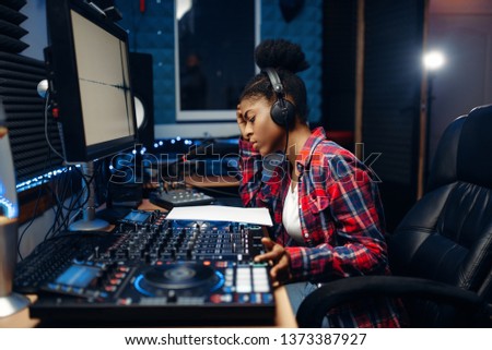 Female sound operator in audio recording studio Royalty-Free Stock Photo #1373387927
