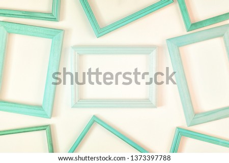 On a white background a lot of turquoise empty frames are laid out. Space for text, layout.
