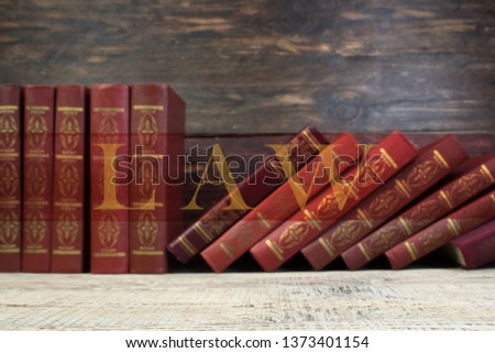 Law concept - Open law book with a wooden judges gavel on table in a courtroom or law enforcement office on wooden background. Copy space for text