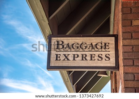 wooden sign that says Baggage Express outside of a train station