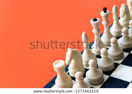 Competition or victory or strategy concept. Chess figures on blue background top view copy space