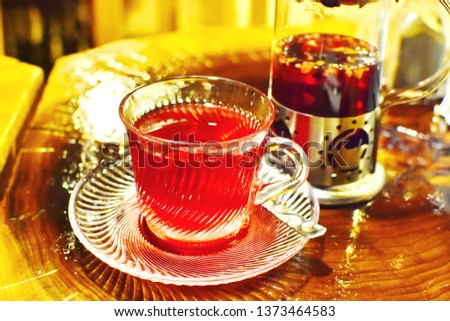 Set of herbal traditional Turkish floral tea on dark gold brown table, soft and selective focus, bokeh tone of red brown hot beverage background 