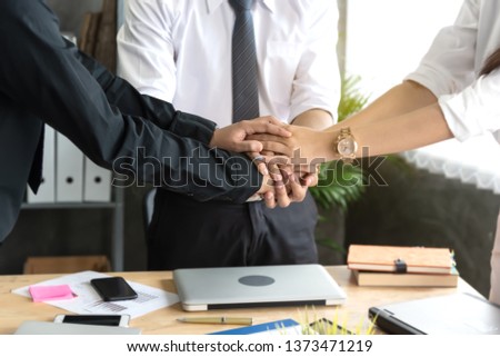 Hand stack and hold together in team for success something or take care after agreement meeting in office. Royalty-Free Stock Photo #1373471219