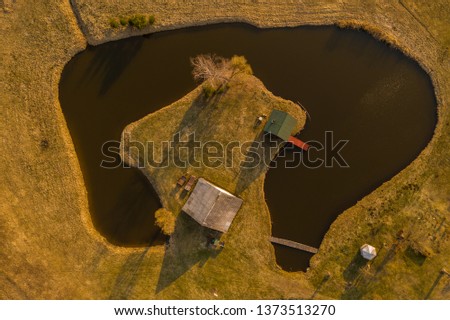 Drone view of house in a small lake peninsula. Drone photography.