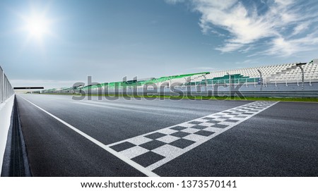 Black and white finish line with dramatic view of a modern race track. Royalty-Free Stock Photo #1373570141