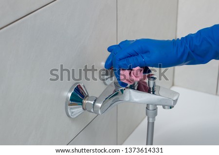 Close-up of shower mixer faucet with limescale, white chalky deposit and stains. Formed on the plumbing system by a combination of soap residues and hard water. Concept of cleaning limescale plumbing Royalty-Free Stock Photo #1373614331